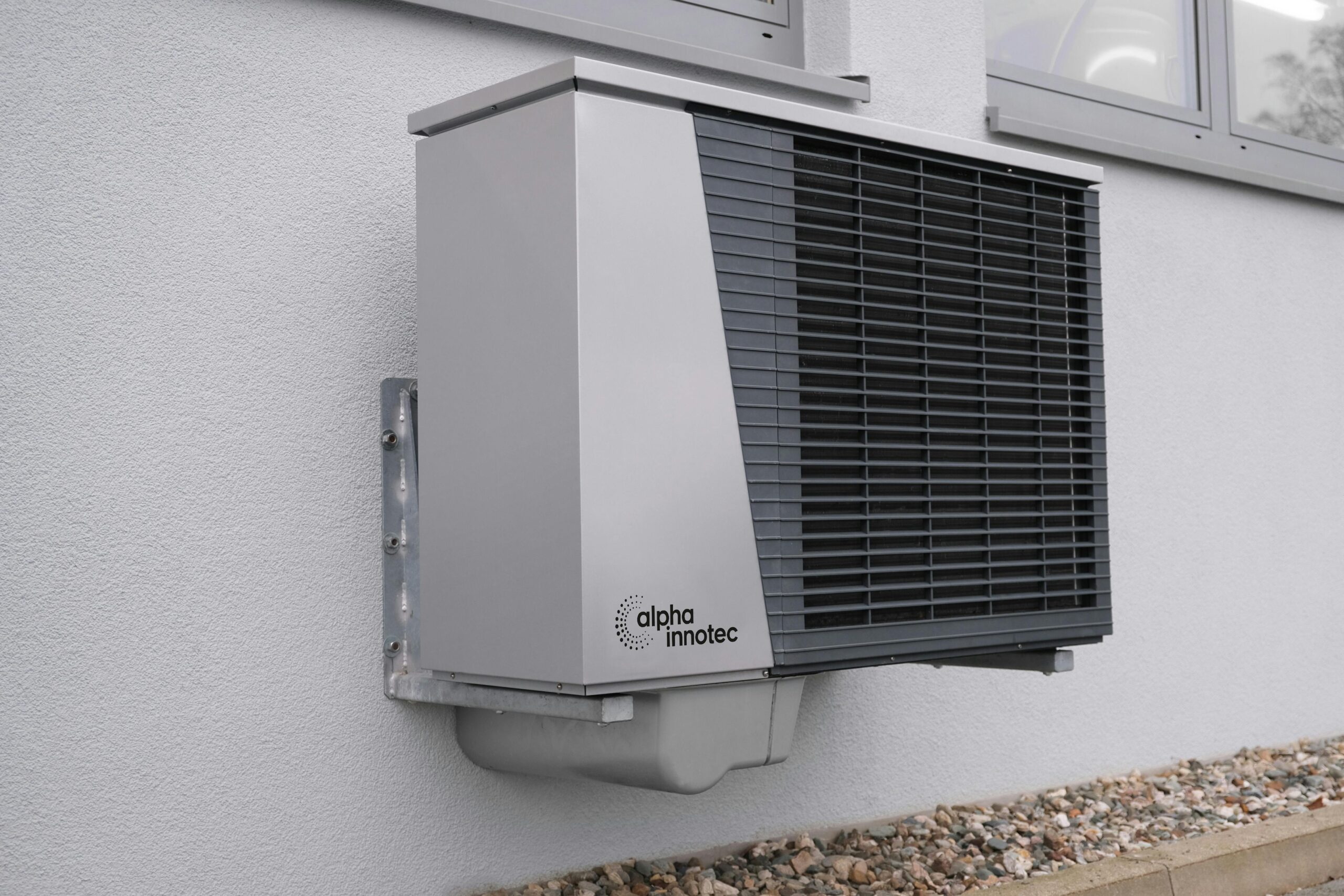 Outdoor air conditioning unit mounted on a residential building exterior.